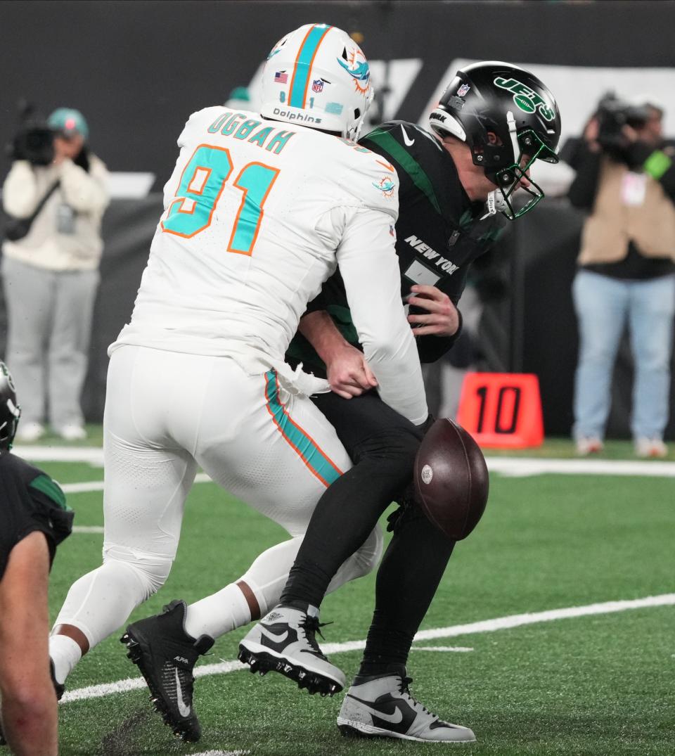 East Rutherford, NJ — November 24, 2023 — Emmanuel Ogbah of Miami strips Jets quarterback Tim Boyle of the ball in the second half as the Miami Dolphins defeated the NY Jets 34-13 at MetLife Stadium on November 24, 2023 in East Rutherford, NJ to play in the first “Black Friday” NFL game.