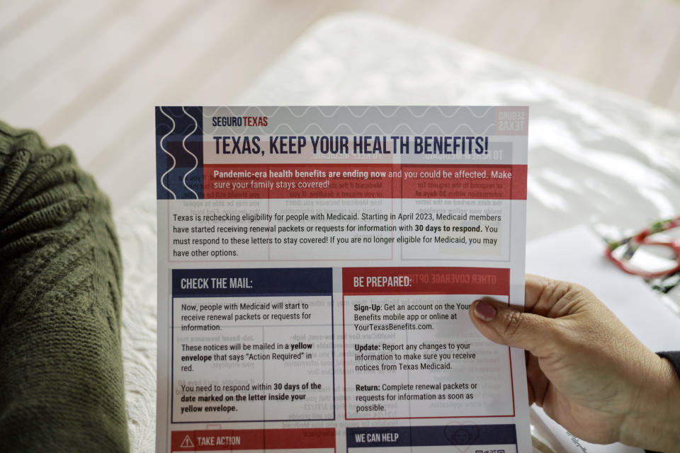 Children's Defense Fund program director Graciela Camarena hands Lucia Salazar a health benefits flyer in Pharr, Texas, Monday, Nov. 13, 2023. As the state reviews Texans' eligibility, some 1 million people have already lost Medicaid and organizations like the one Graciela works for assist people in applying again. (AP Photo/Michael Gonzalez)