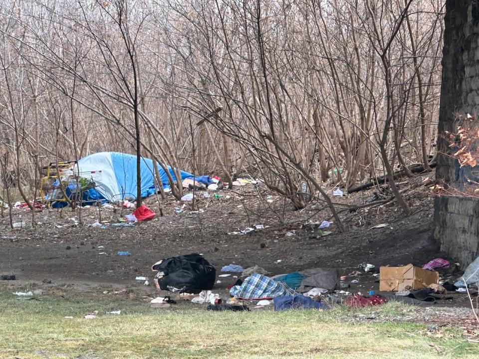 A tent, a sleeping bag, garbage, and other signs of homeless living near the Legacy Beacon construction site on Windsor's riverfront at Caron Avenue.