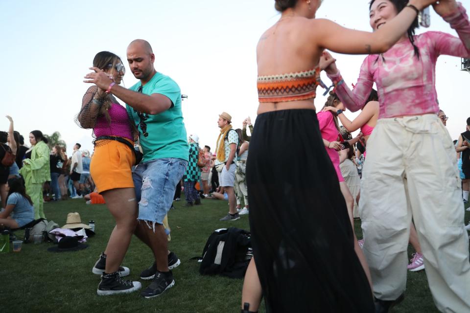 Erika Rengifo and Julian Delgado of San Jose dance together during the Rosalia performance during the Coachella Valley Music and Arts Festival in Indio, Calif., on Saturday, April 15, 2023. 