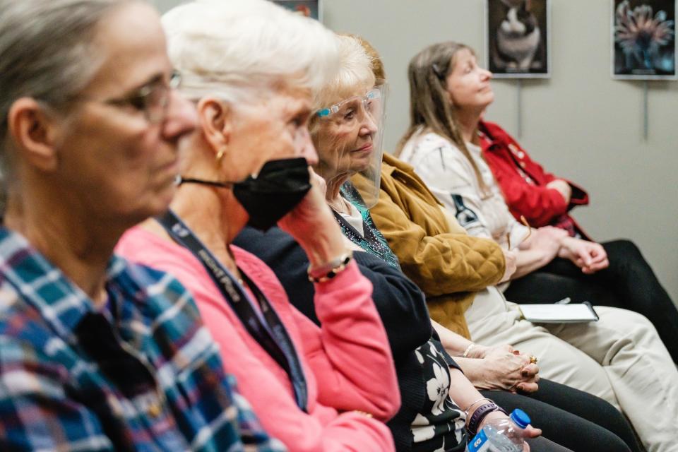 Audience members watch actress Juliette Regnier as she portrays former U.S. Supreme Court Justice Ruth Bader Ginsburg during a presentation at the Dover Public Library.