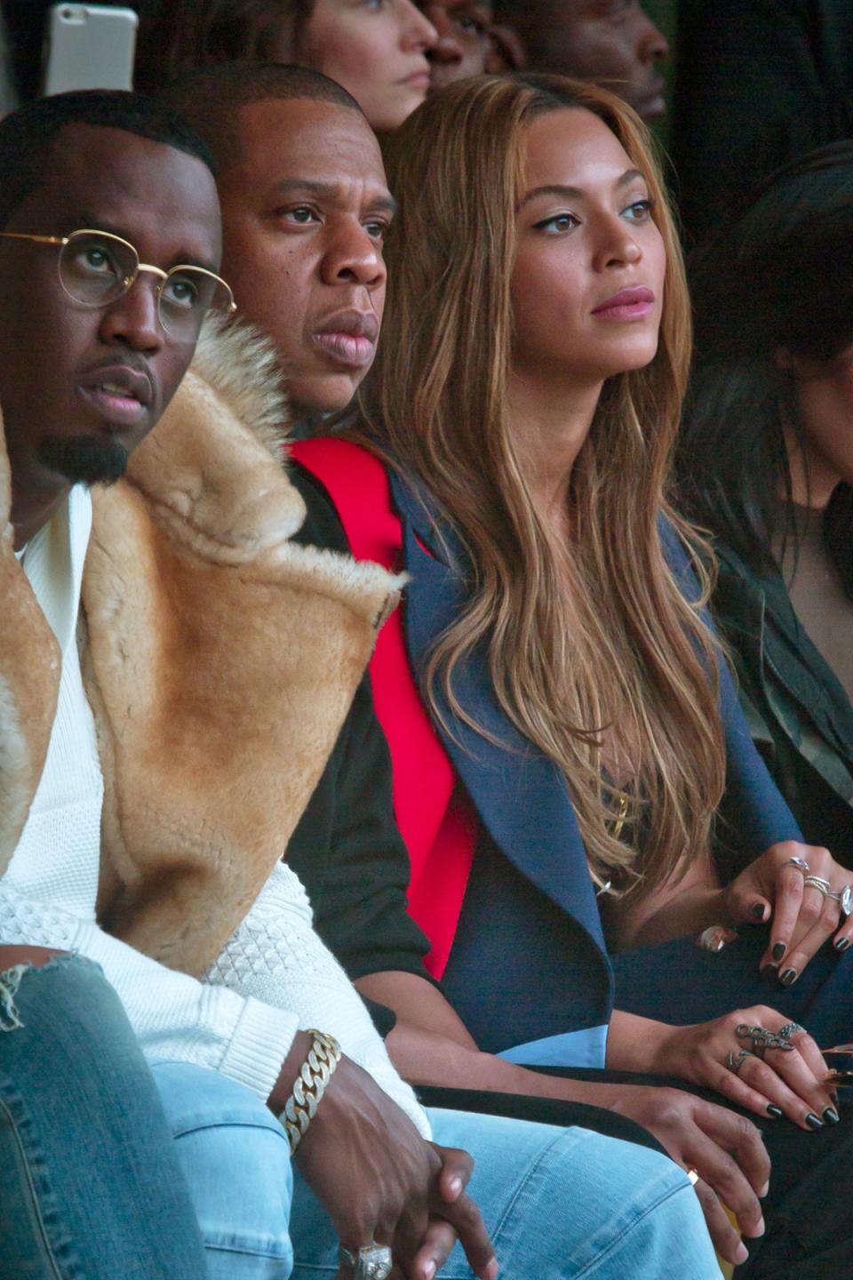 Taking a look: Sean Combs, Jay Z, and Beyonce look engrossed as they watch the catwalk (Picture: AP Photo/Bebeto Matthews) (AP Photo/Bebeto Matthews)