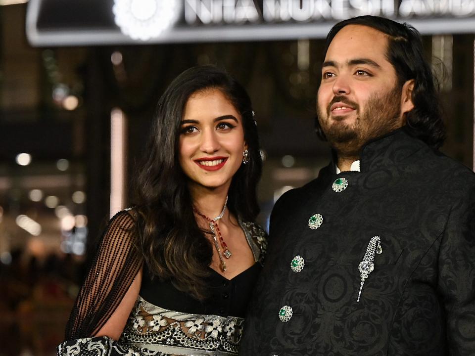 Anant Ambani (R), son of Indian businessman Mukesh Dhirubhai Amani, and Radhika Merchant pose for pictures during the inauguration of the Nita Mukesh Ambani Cultural Centre (NMACC) at the Jio World Centre (JWC) in Mumbai.