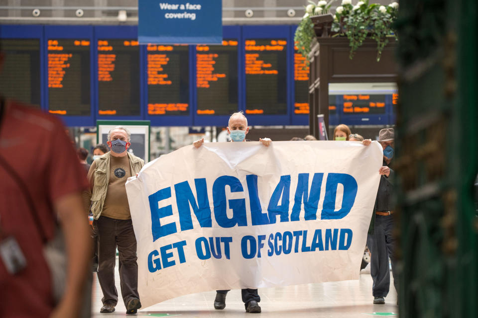 The protesters held up a banner that read 'England Get Out of Scotland' (Picture: SWNS)