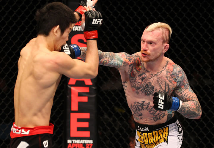 SAITAMA, JAPAN - FEBRUARY 26: (R-L) Bart Palaszewski punches Hatsu Hioki during the UFC 144 event at Saitama Super Arena on February 26, 2012 in Saitama, Japan.