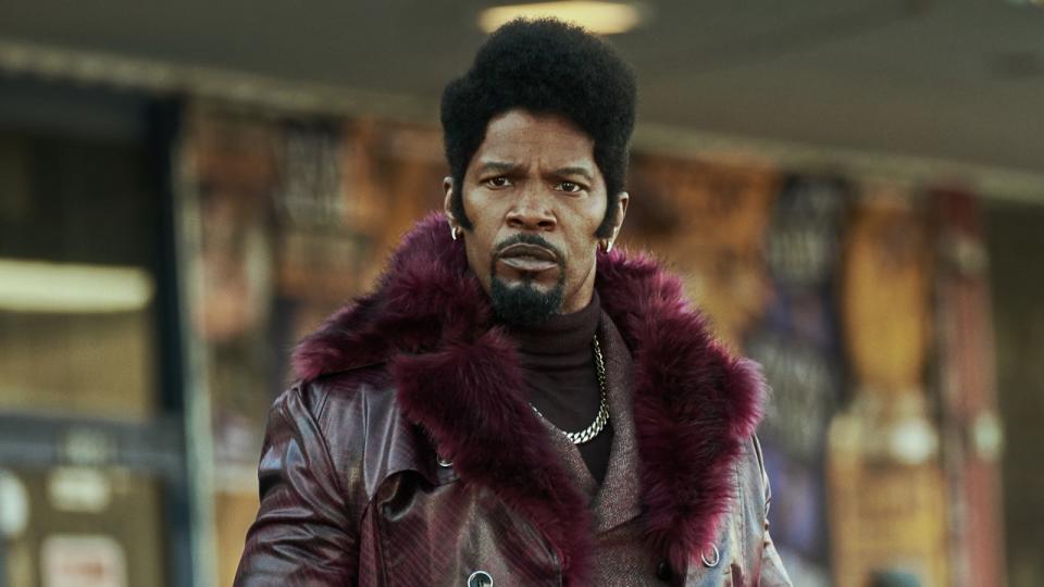 Slick Charles wearing fur-lined coat in They Cloned Tyrone