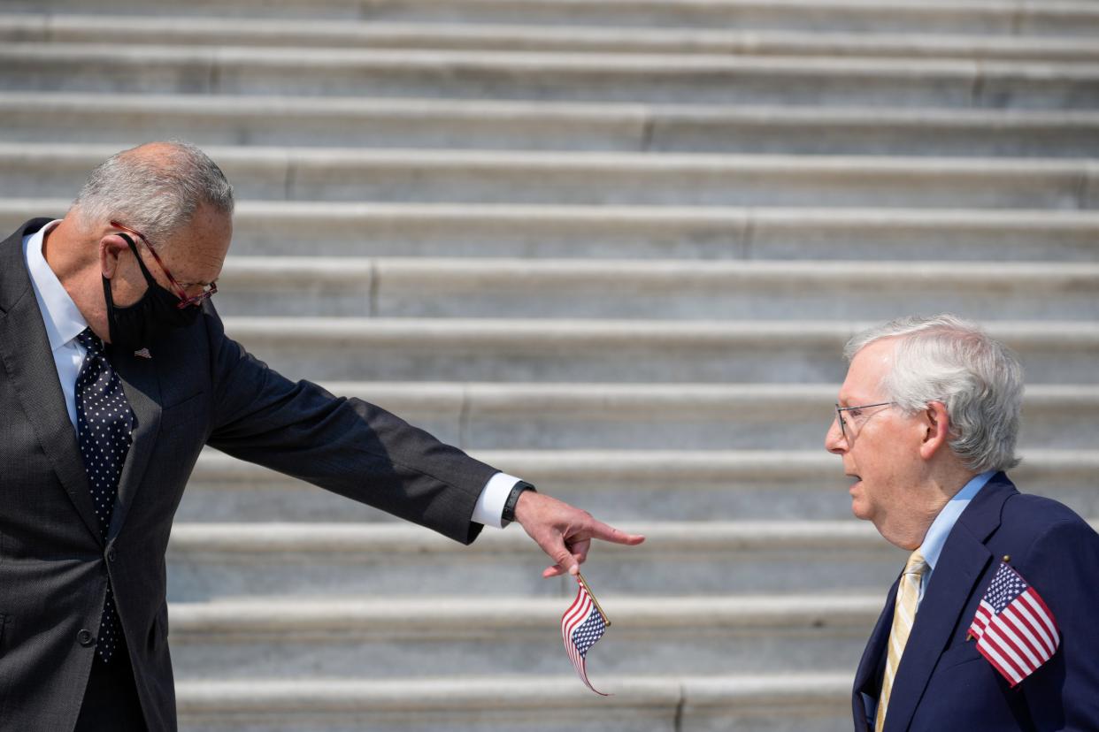 Sen. Chuck Schumer points at Sen. Mitch McConnell on the steps of the US Capitol