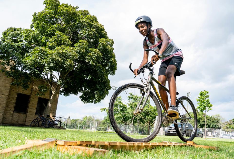 Joseph McCrary, a junior at Wauwatosa East High School, practices some mountain biking drills on the balance beam at MacDowell Montessori School on Thursday, July 21, 2022.