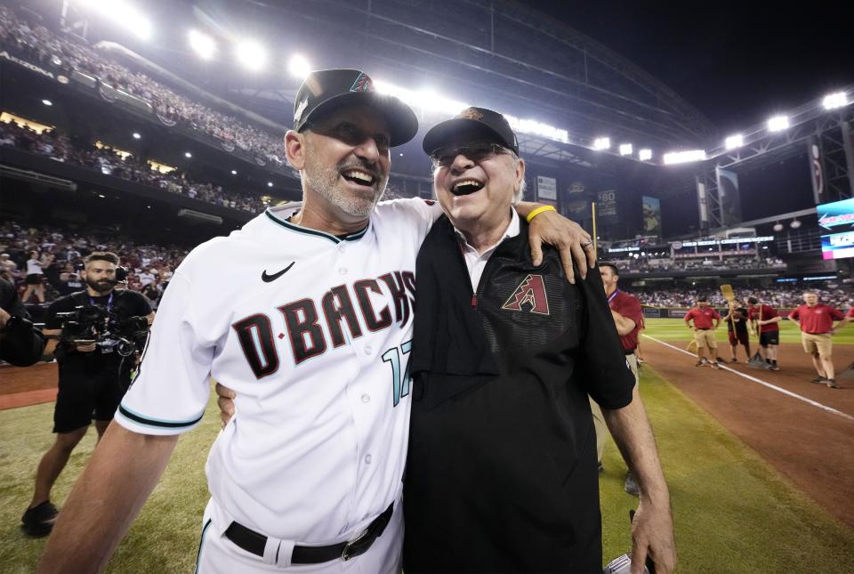 Arizona Diamondbacks manager Torey Lovullo (17) and owner Ken Kendrick celebrate after sweeping the Los Angeles Dodgers 3-0 to win the NLDS at Chase Field.