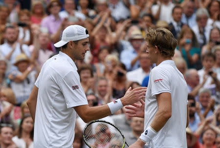 Tennis - Wimbledon - All England Lawn Tennis and Croquet Club, London, Britain - July 13, 2018 South Africa's Kevin Anderson shakes hands with John Isner of the U.S. after winning their semi final match REUTERS/Tony O'Brien