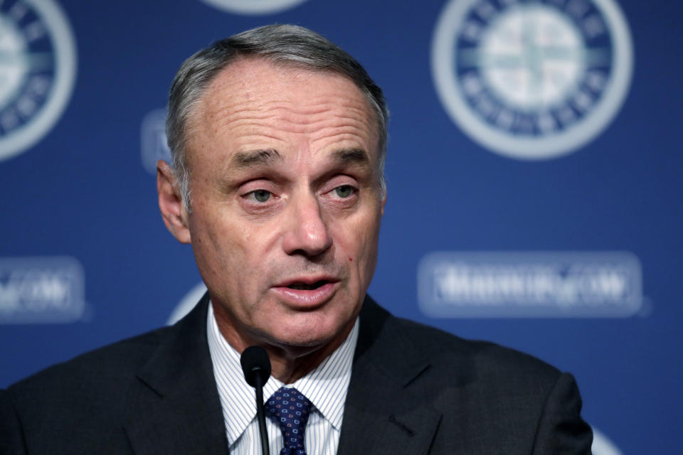 Baseball Commissioner Rob Manfred addresses reporters before a baseball game between the Seattle Mariners and the Houston Astros on Tuesday, June 4, 2019, in Seattle. (AP Photo/Elaine Thompson)