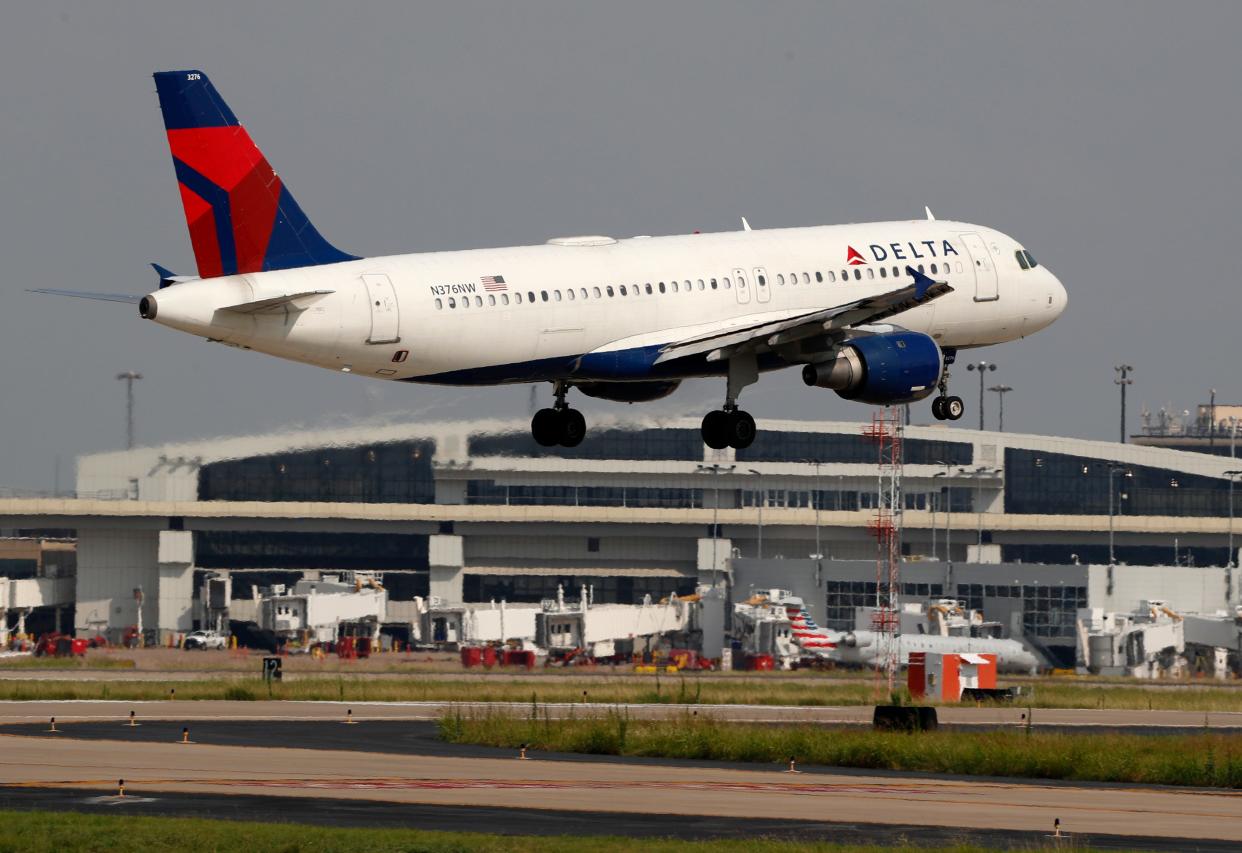 FILE - In this June 24, 2019, file photo a Delta Air Lines aircraft makes its approach at Dallas-Fort Worth International Airport in Grapevine, Texas. Delta Air Lines reports earns Tuesday, Oct. 8. (AP Photo/Tony Gutierrez, FIle)