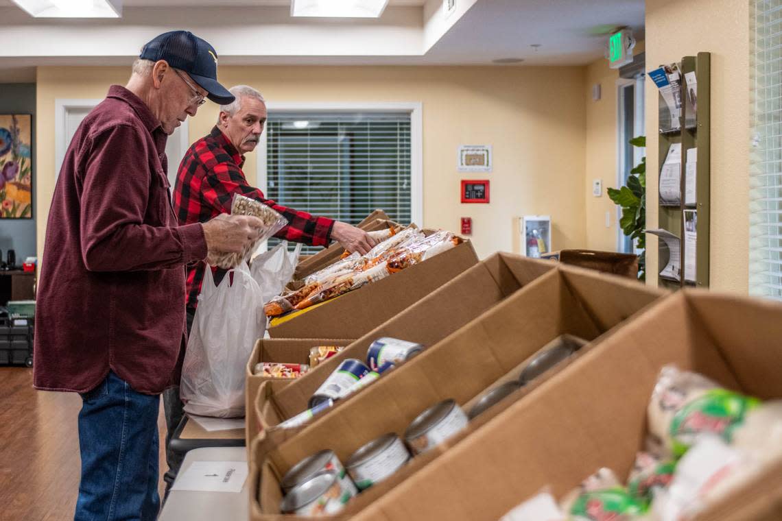 Elk Grove Food Bank Services volunteers Ron Witt, left, and Joe Allen, pack up bags of food that will be delivered to seniors at the Arbor Creek Family Apartments on Nov. 21. The food bank wants to restart its mobile cooking classes for seniors with donations from Book of Dreams.