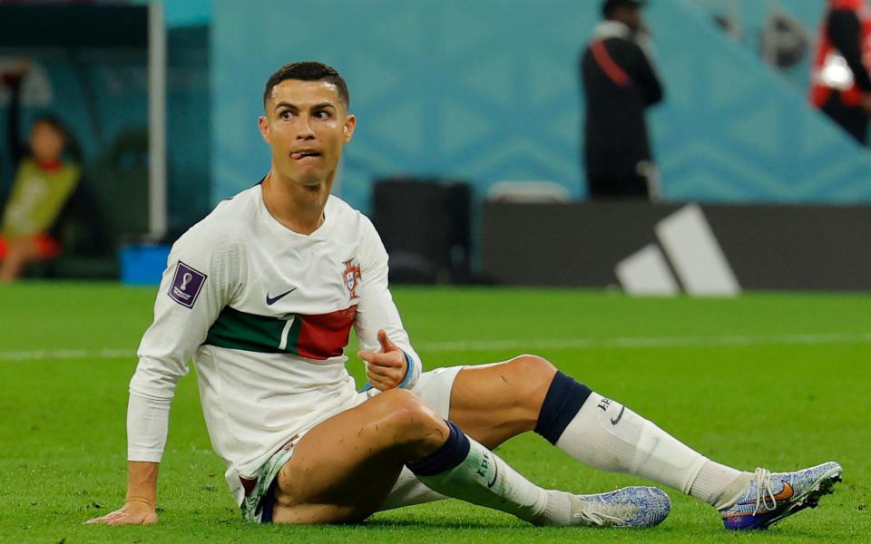 Portugal's forward #07 Cristiano Ronaldo reacts after a fall during the Qatar 2022 World Cup Group H football - AFP