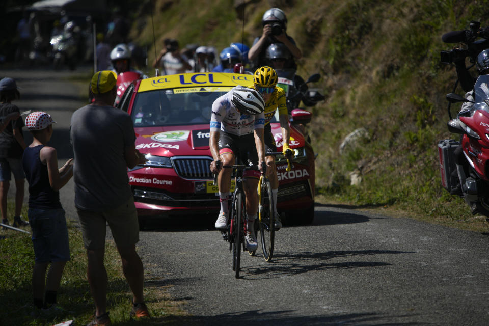 Slovenia's Tadej Pogacar, wearing the best young rider's white jersey, looks back to see if he managed to break away from stage winner Denmark's Jonas Vingegaard, wearing the overall leader's yellow jersey, during the eighteenth stage of the Tour de France cycling race over 143.5 kilometers (89.2 miles) with start in Lourdes and finish in Hautacam, France, Thursday, July 21, 2022. (AP Photo/Daniel Cole)