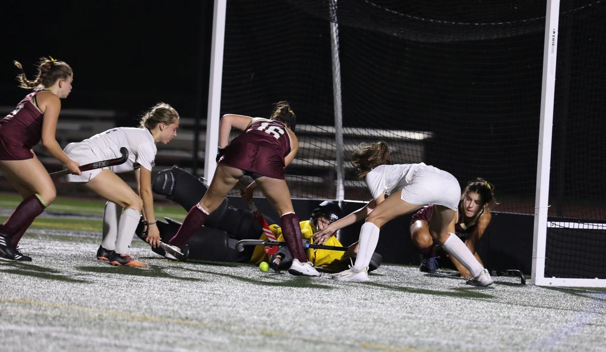 Pittsford Sutherland's Elizabeth Rumble and teammate Hanna Hemmerich try and get the ball past Pittsford Mendon's Shannon Moynihan and goalie Morgan Parrinello to score. Parrinello was able to stop the ball.