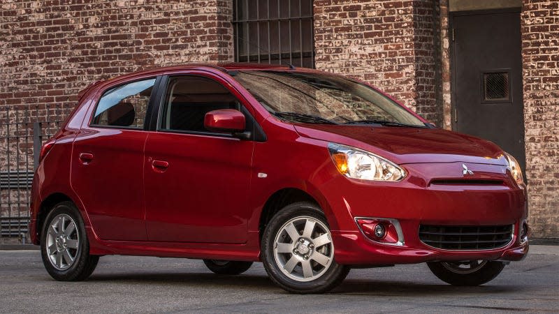 A photo of a red Mitsubishi Mirage hatchback. 