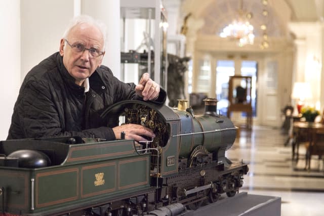 Undated handout photo issued by Dreweatts & Bloomsbury Auctions of Pete Waterman with a 7 1/4 inch gauge model of the Great Western Railway Class 3700 4-4-0 tender locomotive No.3440 'City of Truro', which he is selling, with an estimate of 100,000 to 120,000 pounds. PRESS ASSOCIATION Photo. Issue date: Thursday April 16, 2015. The pop producer's finest scratch-built model trains from his collection - seen as the Faberge Eggs of the model locomotives world - will go on sale in Mayfair, central London, this evening. The collection of 56 engines includes what Waterman argues is the finest model ever built -  the Beyer Goods, valued at ï¿½100,000-120,000. Alongside his music career, Waterman, 68, has also carved out a role for himself in the world of train modelling and railway preservation over the past 50 years. As the world's leading collector and patron of modellers, he has decided to sell what amounts to around a tenth of his collection in order to raise enough money to secure the future of Waterman Railway Heritage Trust, which holds his collection of full-size steam engines, housed at sites around the country. See PA story SALE Waterman. Photo credit should read: Dreweatts & Bloomsbury Auctions/PA WireNOTE TO EDITORS: This handout photo may only be used in for editorial reporting purposes for the contemporaneous illustration of events, things or the people in the image or facts mentioned in the caption. Reuse of the picture may require further permission from the copyright holder.