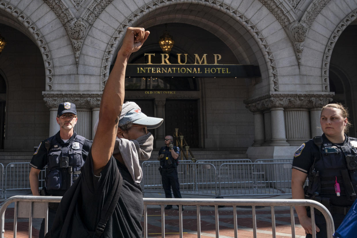 WASHINGTON, DC - JUNE 03: Demonstrators peacefully protest outside of Trump International Hotel Washington on Pennsylvania Avenue on June 3, 2020 in Washington, DC. Protests in cities throughout the country continue in the wake of the death of George Floyd, a black man who died while in police custody in Minneapolis on May 25. (Photo by Drew Angerer/Getty Images)