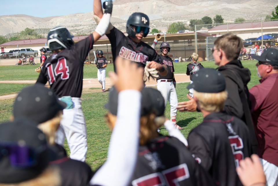 Riverside Prep’s Cayden Johnson, rear right, reacts in celebration as Eric Logsdon, center, celebrates after scoring a run during the second inning on Thursday, April 27, 2023. Hesperia Christian beat Riverside Prep 6-4 to claim the Cross Valley League title.