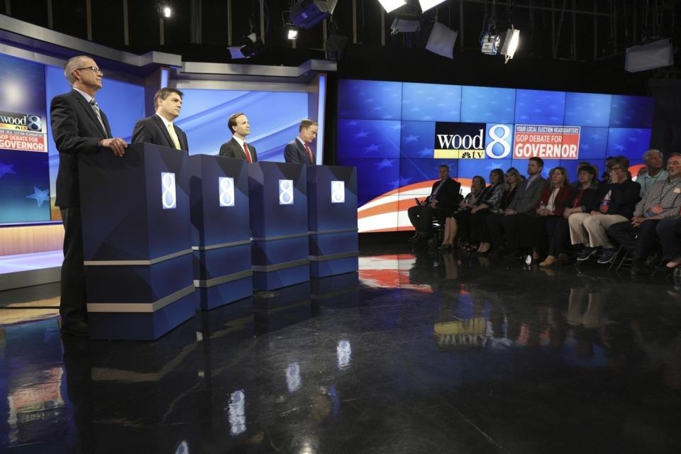 FILE In this May 9, 2018 file photo, from left Republicans gubernatorial candidates Dr. Jim Hines, Michigan state Sen. Patrick Colbeck, Lt. Gov. Brian Calley, and Attorney General Bill Schuette are seen during the GOP's first debate in Grand Raids, Mich. (Michael Buck/Wood-TV8 via AP, POOL)