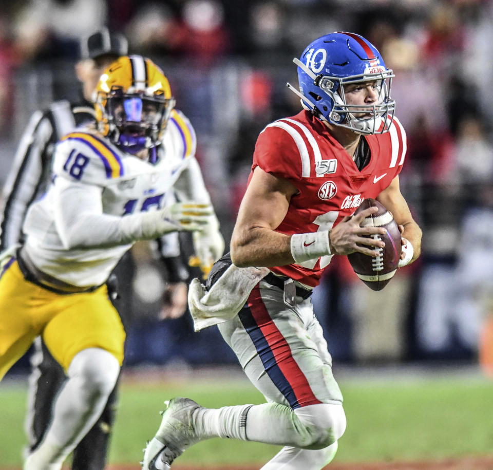 Mississippi quarterback John Rhys Plumlee (10) looks for a receiver as LSU's K'Lavon Chasson gives chase during an NCAA college football game Saturday, Nov. 16, 2019, in Oxford, Miss. (Bruce Newman/Oxford Eagle via AP)