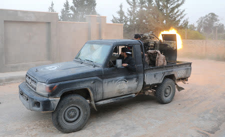 Members of the Libyan internationally recognised government forces fire during fighting with Eastern forces in Ain Zara in Tripoli, Libya April 20, 2019. REUTERS/Hani Amara