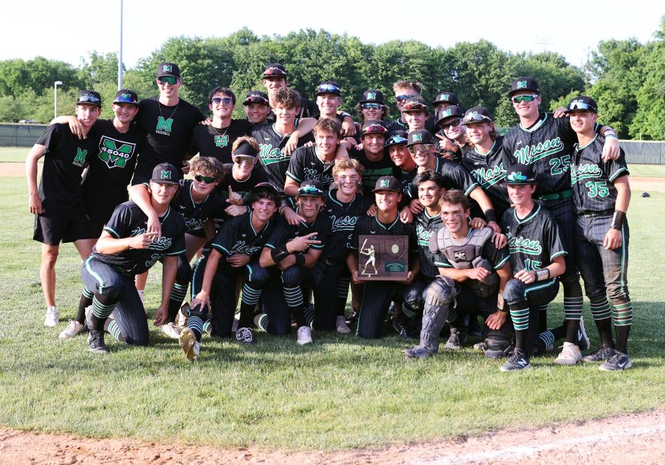 Mason players celebrate with the regional championship trophy after the game with Moeller at Midland Field June 4, 2022.