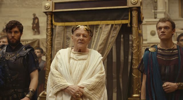 <p>Reiner Bajo/Peacock</p> Tom Hughes as Titus, Anthony Hopkins as Emperor Vespasian, Jojo Macari as Domitian on 'Those About to Die'