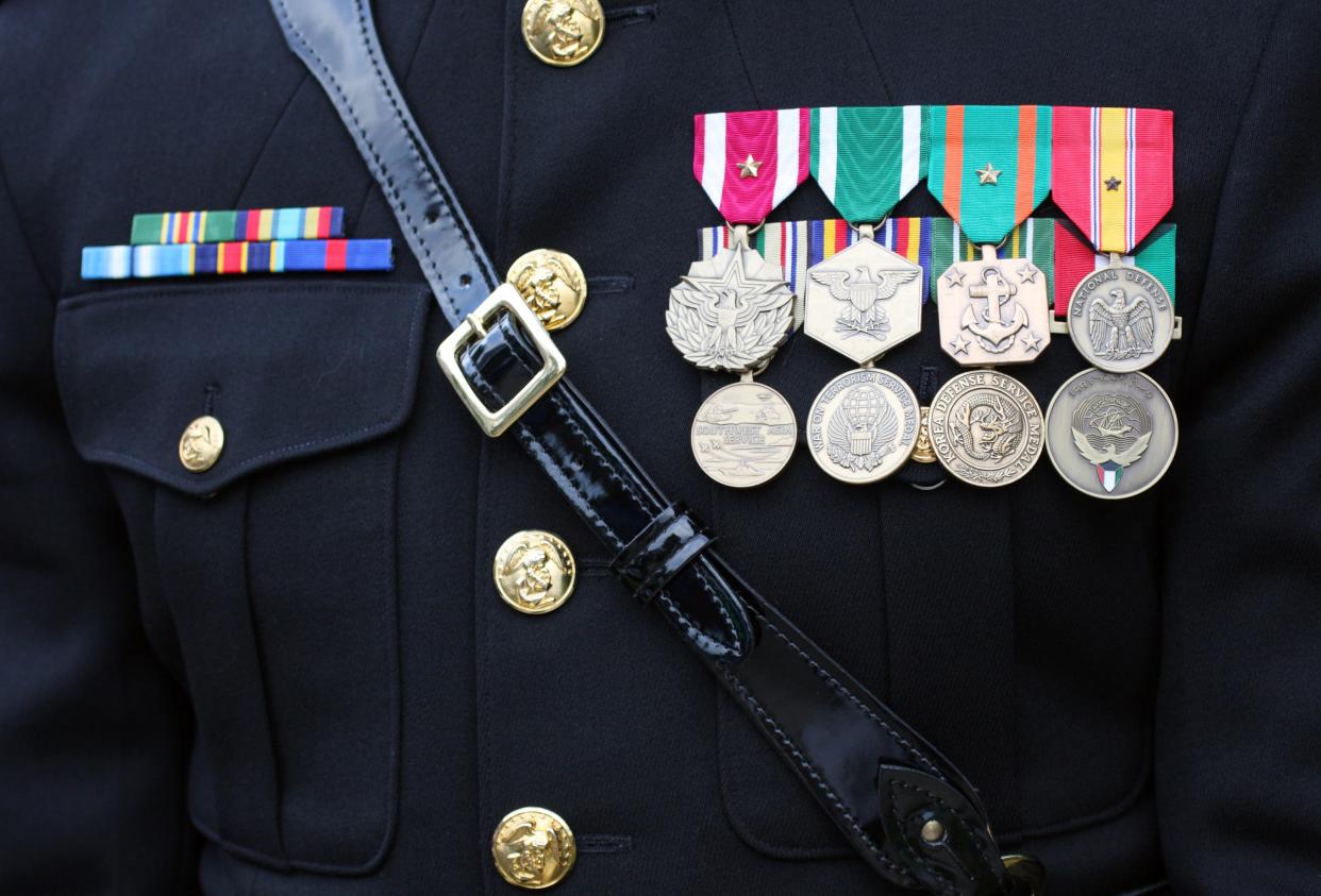 A U.S. military dress uniform with many medals and ribbons.