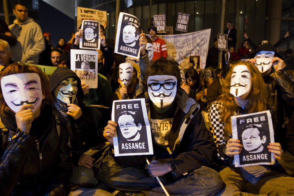 FILE - Supporters of WikiLeaks founder Julian Assange hold posters with his photo during a protest in front of the British Embassy in Madrid, Spain, Dec. 11, 2010. WikiLeaks founder Julian Assange is facing what could be his final court hearing in England over whether he should be extradited to the United States to face spying charges. The High Court will hear two days of arguments next week over whether Assange can make his pitch to an appeals court to block his transfer to the U.S. (AP Photo/File)