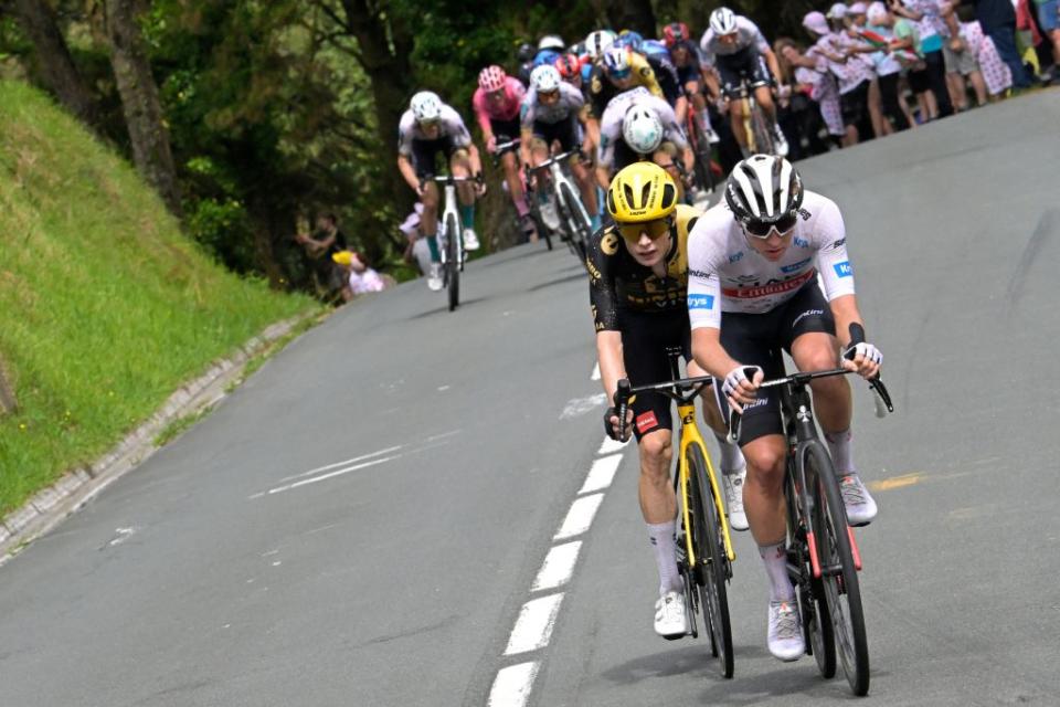 JumboVismas Danish rider Jonas Vingegaard L and UAE Team Emirates Slovenian rider Tadej Pogacar wearing the best young riders white jersey R cycle on the Col Jaizkibel during the 2nd stage of the 110th edition of the Tour de France cycling race 2089 km between VitoriaGasteiz and San Sebastian in northern Spain on July 2 2023 Photo by Bernard PAPON  AFP Photo by BERNARD PAPONAFP via Getty Images