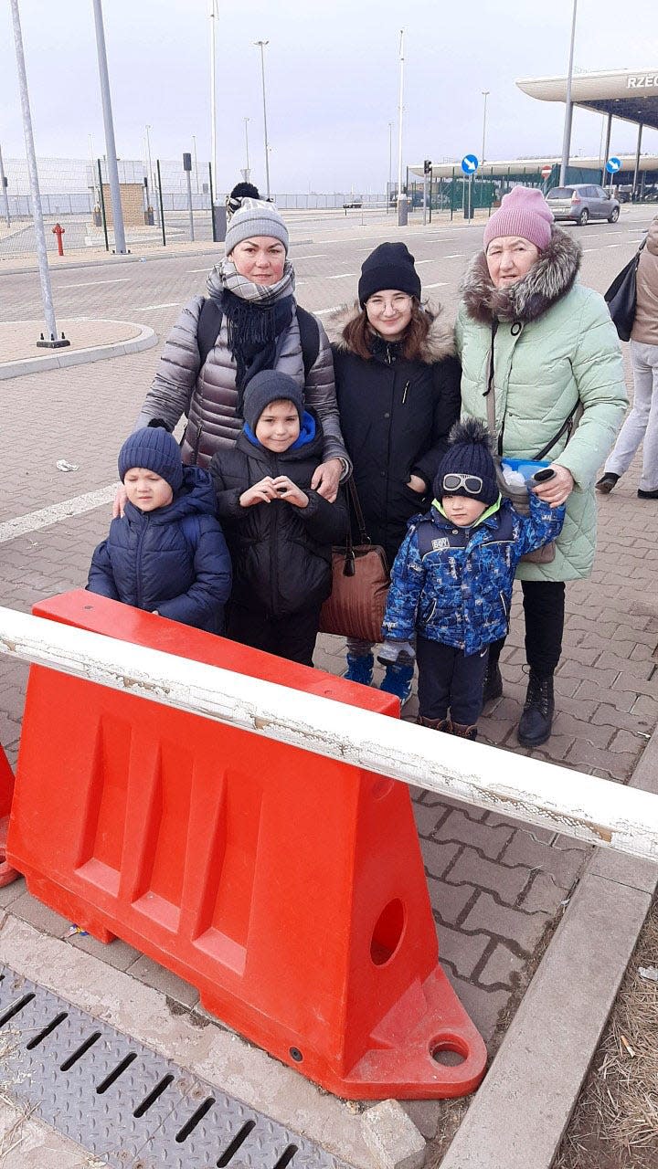Maryna Pavlenko, left, with her children, Nikita,5, and Pavlo, 8, at the Polish border with Volodymyr's mother, right, and his brother's children in March 2022 as they fled the Russian invasion. 