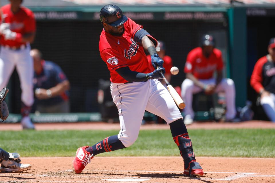 Cleveland Guardians designated hitter Franmil Reyes hits a one-run double against the Minnesota Twins during the first inning in the first baseball game of a doubleheader, Tuesday, June 28, 2022, in Cleveland. (AP Photo/Ron Schwane)