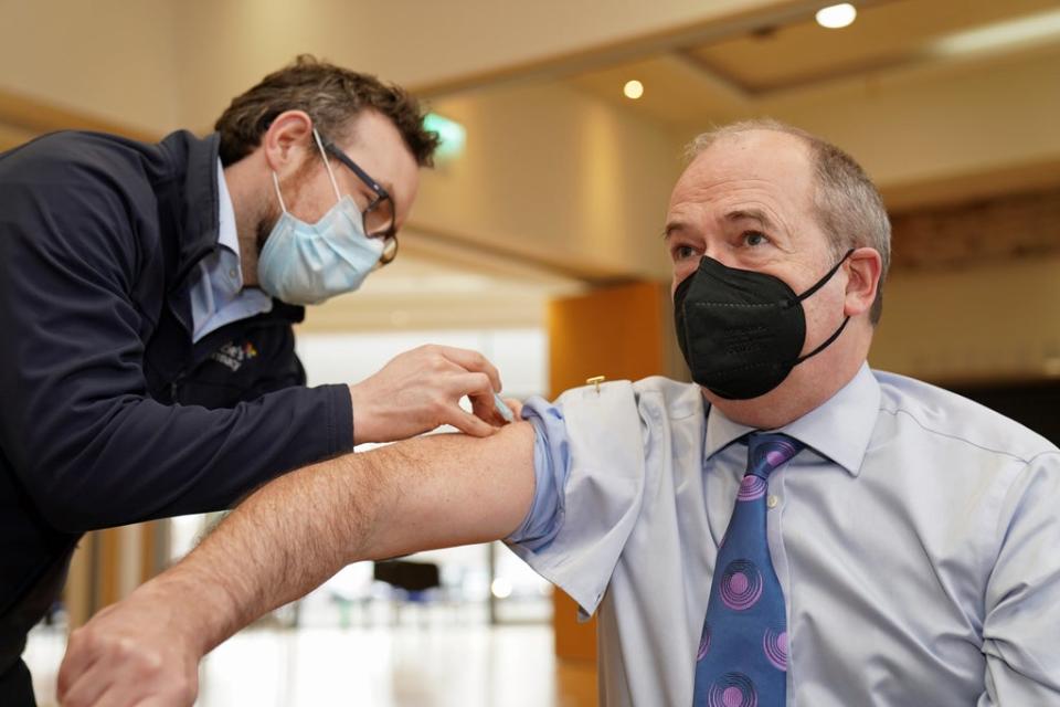 Sir Michael McBride receiving his Covid-19 booster jab from community pharmacist Peter Rice (Brian Lawless/PA) (PA Wire)