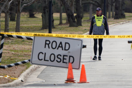 A man walks near gates blocking the road leading to Haynes Point in East Potomac Park on the 22nd day of a partial government shutdown in Washington, U.S., January 12, 2019. REUTERS/Joshua Roberts