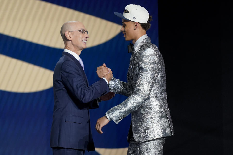 Dyson Daniels, right, is congratulated by NBA Commissioner Adam Silver after being selected eighth overall by the New Orleans Pelicans in the NBA basketball draft, Thursday, June 23, 2022, in New York. (AP Photo/John Minchillo)