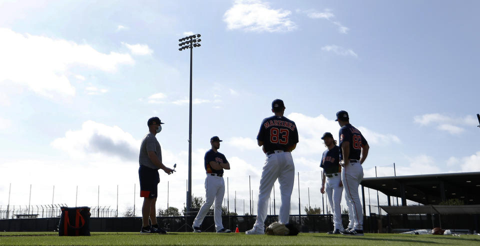 Houston Astros pitchers stand on the field during baseball spring training in West Palm Beach, Fla., Tuesday, Feb. 23, 2021. (Karen Warren/Houston Chronicle via AP)