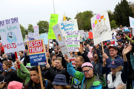 Protestors hold signs during the March For Science in Seattle, Washington, U.S. April 22, 2017. REUTERS/David Ryder