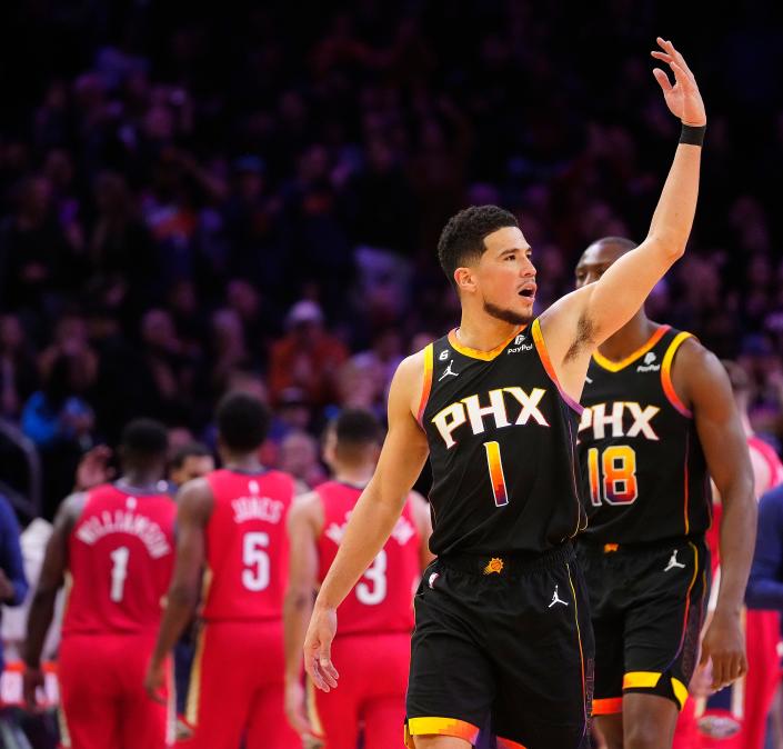 December 17, 2022; Phoenix, Ariz; USA; Suns guard Devin Booker (1) pumps up the crowd agaisnt the Pelicans during the second half at the Footprint Center. 
