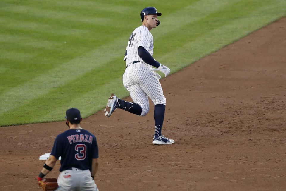 New York Yankees' Aaron Judge, right, runs past Boston Red Sox second baseman Jose Peraza (3) after hitting a three-run home run during the second inning of a baseball game Sunday, Aug. 2, 2020, at Yankee Stadium in New York. (AP Photo/Kathy Willens)