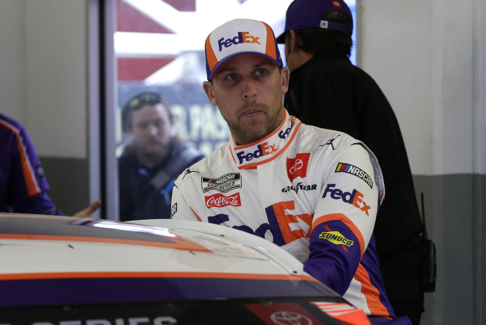 FILE - In this Feb. 14, 2020, file photo, Denny Hamlin climbs into his car as he gets ready to practice for the NASCAR Daytona 500 auto race at Daytona International Speedway in Daytona Beach, Fla. Hamlin is starting his own race car team in partnership with Charlotte Hornets owner Michael Jordan and Bubba Wallace as the driver. (AP Photo/Terry Renna, File)