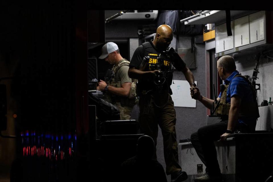 Sgt. James Hendricks shakes hands with a fellow trooper after the conclusion a standoff between an alleged gunman and police forces on June 18, 2024.