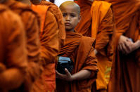 <p>Buddhist monks walk down a road asking for alms during the annual Vesak festival, in Colombo, Sri Lanka May 11, 2017. (Photo: Dinuka Liyanawatte/Reuters) </p>