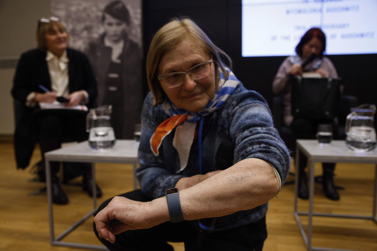 Holocaust survivor Maria Horl shows her tattoo with her Auschwitz inmate number as she attends a meeting of survivors with media in Oswiecim, Poland, Thursday, Jan. 26, 2023. Survivors of Auschwitz-Birkenau are gathering to commemorate the 78th anniversary of the liberation of the Nazi German death camp in the final months of World War II, amid horror that yet another war has shattered the peace in Europe. The camp was liberated by Soviet troops on Jan. 27, 1945. (AP Photo/Michal Dyjuk)