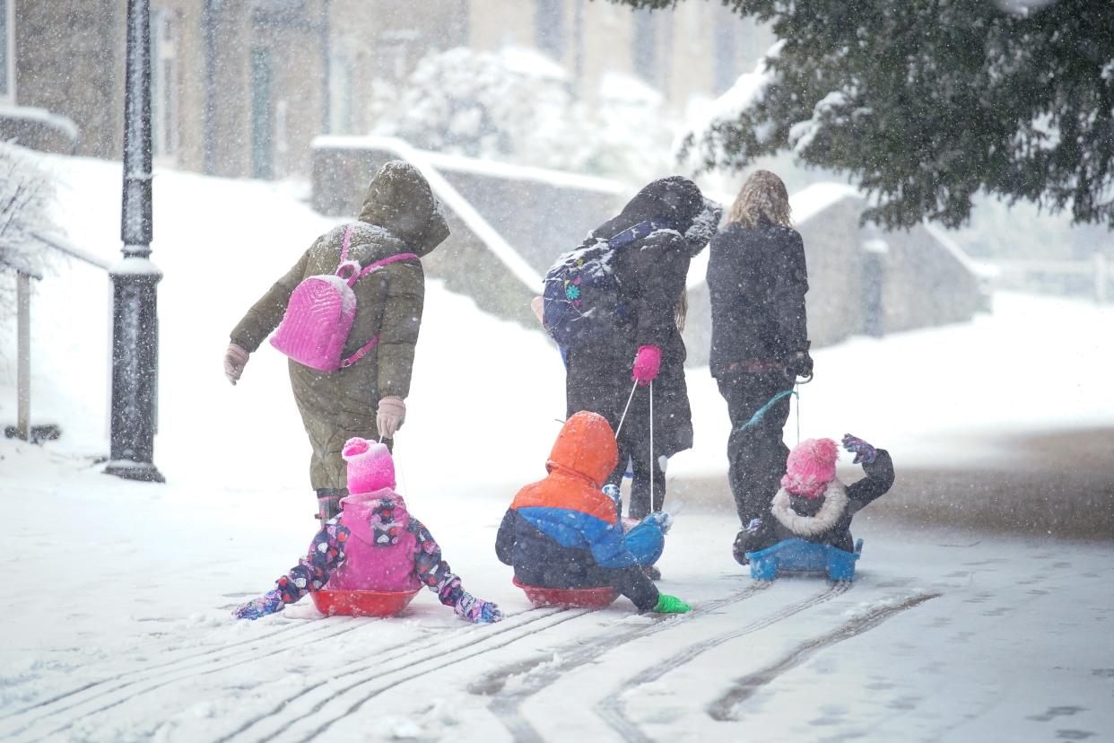 Children being pulled on sleds in the Peak District (Peter Byrne/PA Wire)