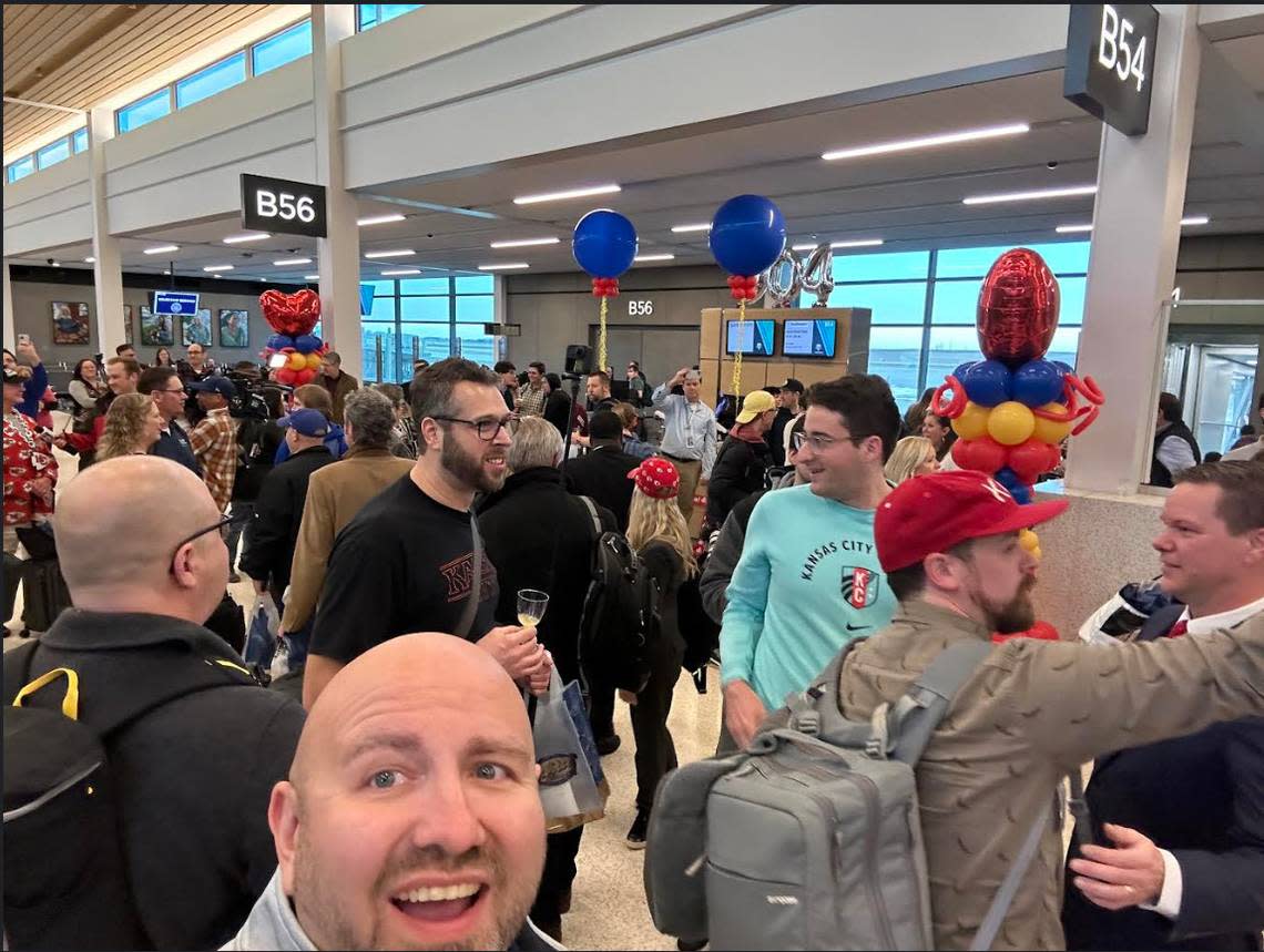 In a provided photo, James Larson, of Overland Park, takes a selfie with other passengers getting off the first flight to arrive at the new KCI terminal on Tuesday, Feb. 28, 2023.