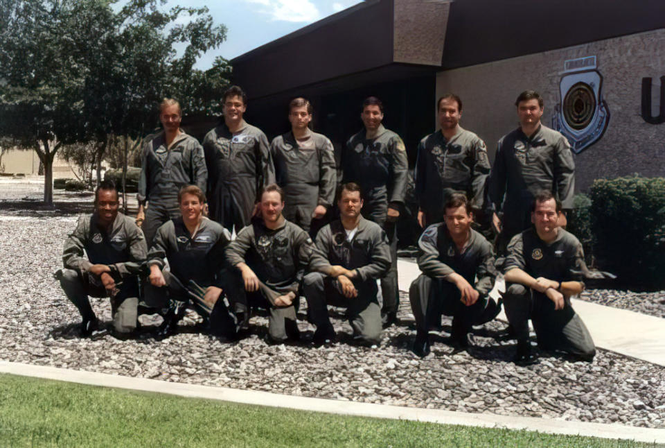 In this image provided by the Brown family, Capt. CQ Brown, Jr., first row left, poses with class 91B F-16 Fighting Falcon graduates from the U.S. Air Force Fighter Weapons Instructor Course, at Nellis Air Force Base, Nev., in 1991. Brown was a Weapons Instructor Course student from April to August 1991, returned as an instructor from September 1992 to October 1994, and served as Weapons School Commandant from July 2005 to May 2007. (Brown family via AP)