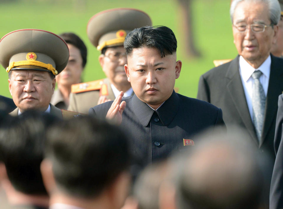 North Korean leader Kim Jong Un, center, attends an inauguration ceremony for a cemetery for Korean War veterans on Thursday, July 25, 2013 in Pyongyang, North Korea marking the 60th anniversary of the signing of the armistice that ended hostilities on the Korean peninsula. (AP Photo/Kyodo News)