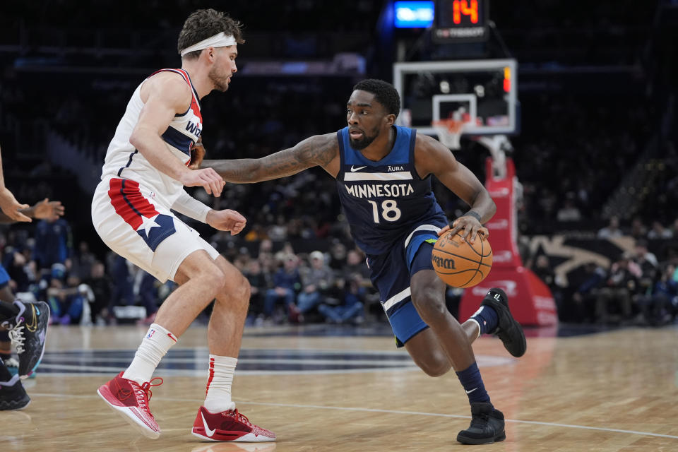 Minnesota Timberwolves guard Shake Milton (18) drives against the defense of Washington Wizards forward Corey Kispert (24) during the second half of an NBA basketball game Wednesday, Jan. 24, 2024, in Washington. (AP Photo/Mark Schiefelbein)